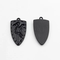 Detailed view of black shield pendant showing winged knight relief and brushed metal texture - Black
