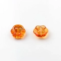 Macro detail of amber orange glass cat paw beads with heart pattern for DIY jewelry - Orange