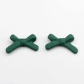 Macro view of matte dark green acrylic bow pendants with holes for DIY jewelry making - Green