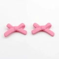 Detailed view of pink acrylic resin bow pendants with center holes for DIY jewelry making - Pink