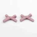 Macro view of pink acrylic resin bow beads for DIY jewelry making and crafts - Dusty Pink