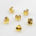 Macro view of six yellow faceted square crystal glass beads for DIY earring making projects - 6mm / Lemon Yellow