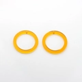 Macro shot of amber resin geometric round pendants with holes for DIY jewelry making - Yellow Circle Style