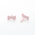 Detailed view of matte pink bow stud earrings with small ring and needle structure - Pink