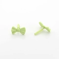 Macro view of mint green matte ribbon earrings showing fine texture and sleek structure - Green