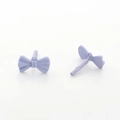 Close-up of lilac purple bow earring studs with a matte finish and metal pins - Purple