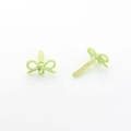 Macro detail of matte light green alloy bow charms with fine sandblasted texture - Hollow Style / Green Hollow