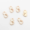Detailed view of six white enamel cat charms with gold alloy plating for DIY jewelry making - White