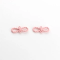 Macro detail of pink matte candy-colored bow charms with twisted rope texture for DIY jewelry - Pink