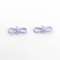 Close-up of matte light purple double-loop bow knot charms for DIY jewelry making - Purple