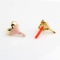 Macro shot of pink heart-shaped earrings with gold metal base and drip glaze detail - Pink