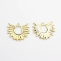 Macro shot of sunburst gold fan pendants showing smooth front and textured logo back - Gold