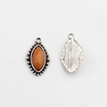 Detailed view of silver flower-shaped marquise charms with orange resin stone inlay - Orange