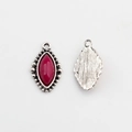 Detail of vintage silver flower pendant with red resin stone and beaded edge texture - Rose Red