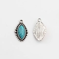 Detailed front and back view of vintage silver flower pendants with turquoise stones - Blue Sodalite