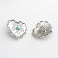 Macro detail showing vintage silver heart button with turquoise inlay and sewing shank - Blue Sodalite