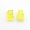 Macro shot of bright yellow translucent resin bear charms for creative DIY jewelry making - Yellow