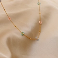 Dainty gold chain necklace with colorful pastel flower beads in a light luxury style - 18K Gold Green + Pink