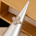 Adjustable silver flower ring featuring white cat eye stones and sparkling zirconia - Palladium White