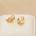 Golden flower clip-on earrings with cream enamel petals and irregular wavy design - Pearl White
