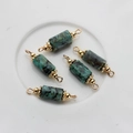 Close-up of 5-piece 14K gold plated natural stone cylinder charms for DIY jewelry - 22*6mm-24*7mm / African Pine Stone