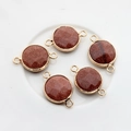 Macro detail of five round brown goldstone pendants with gold plated double loops - Dusty Pink