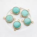 Detailed view of five light blue faceted gemstone connectors with gold-plated double loops - Cyan