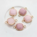 Detailed view of five square pink stone charms with gold-plated edges and double jump rings - Pink