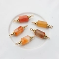 Detailed macro view of five 14K gold-plated natural agate stone cylinder pendants for jewelry - 22*6mm-24*7mm / Orange Persian Stone