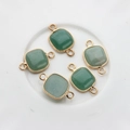 Close-up of green square natural stone pendants with gold plated dual connector rings - Green