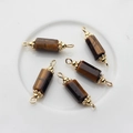 Macro shot of 5 tiger eye stone pendants with 14K gold plated caps and hanging loops - 22*6mm-24*7mm / Tiger's Eye
