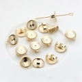 Macro detail of 14K gold plated flower earring backs and S925 engraved jewelry components - Round Earring Backs / 14K Gold