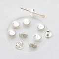 Close-up of 925 sterling silver flower ear nuts showing detailed petal texture on white tray - Round Earring Backs / Silver