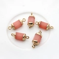 Detailed view of five hexagonal rose quartz pendants with gold caps and double bails - Orange Pink