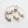 Detail of five hexagonal natural stone connectors with gold plated caps and double loops - White