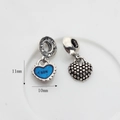 Détail macro du pendentif cœur argenté avec émail bleu, gravure SON et dos texturé - Cœur bleu