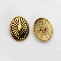Macro detail of vintage gold oval flower metal concho buttons with sunburst pattern - Antique Gold