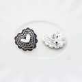 Macro detail of vintage heart alloy buttons with embossed patterns and silver finish - Small / Silver