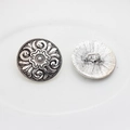Detail of vintage silver star buttons with floral relief and sewing shank on back - Floral Relief Style
