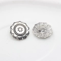 Detail of vintage silver zinc alloy buttons with sunburst flower relief and sewing shank - Antique Silver