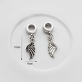 Detailed view of silver wing charms with feather texture, sized 16mm by 6mm for jewelry - Silver Wings