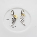 Detail of silver wing charms with gold heart accents and 20mm height dimensions - Gold Wings