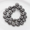 Macro shot of dark grey lava stone beads with natural texture on a white plate - 13*6mm 1pc / Grey Black