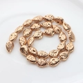 Macro view of gold-plated teardrop lava stone beads with porous texture for DIY jewelry - 14x10mm / Gold