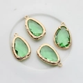 Detail of four light green faceted teardrop pendants with 14K gold plated edging for DIY - Fruit Green
