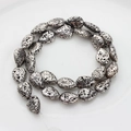 Macro detail of silver plated teardrop lava stone beads with porous natural texture - 14x10mm / Silver