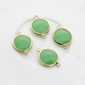 Close-up of four 16mm light green faceted crystal charms with gold double-loop connectors - Green Jade