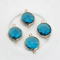 Macro detail of 16mm round blue faceted crystal pendants with gold-plated double loops - Peacock Blue