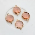 Detailed view of 16mm faceted pink crystal connectors with gold-plated double loops - Water Red