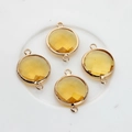 Close-up of 16mm yellow faceted crystal pendants with double-hole gold-plated frames - Gold Yellow